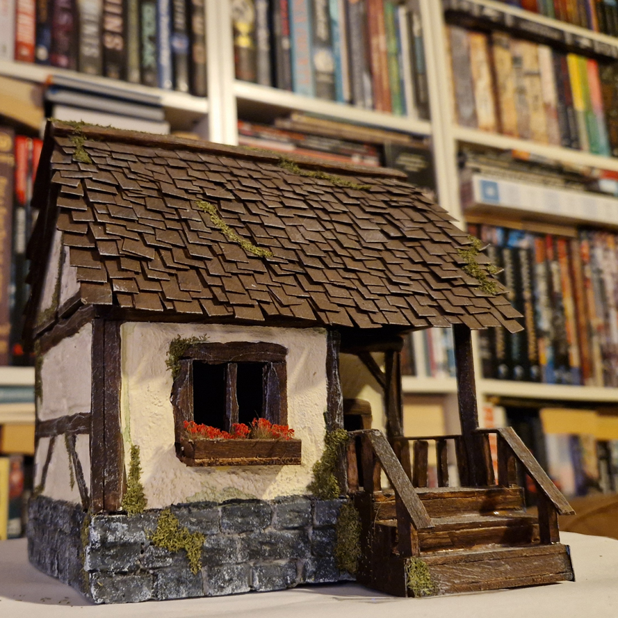 Built and painted miniature house in wattle and daub architecture style