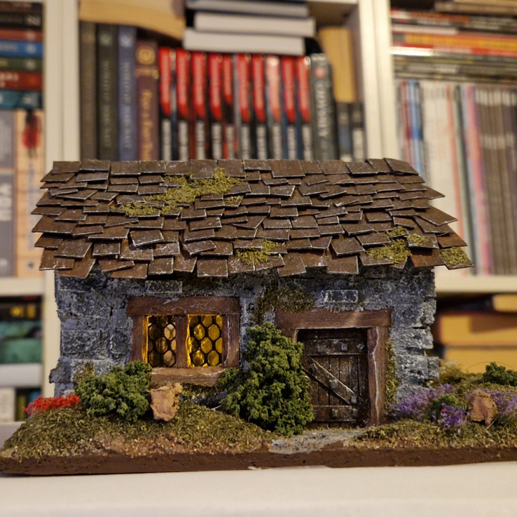 Miniature brick house with light inside