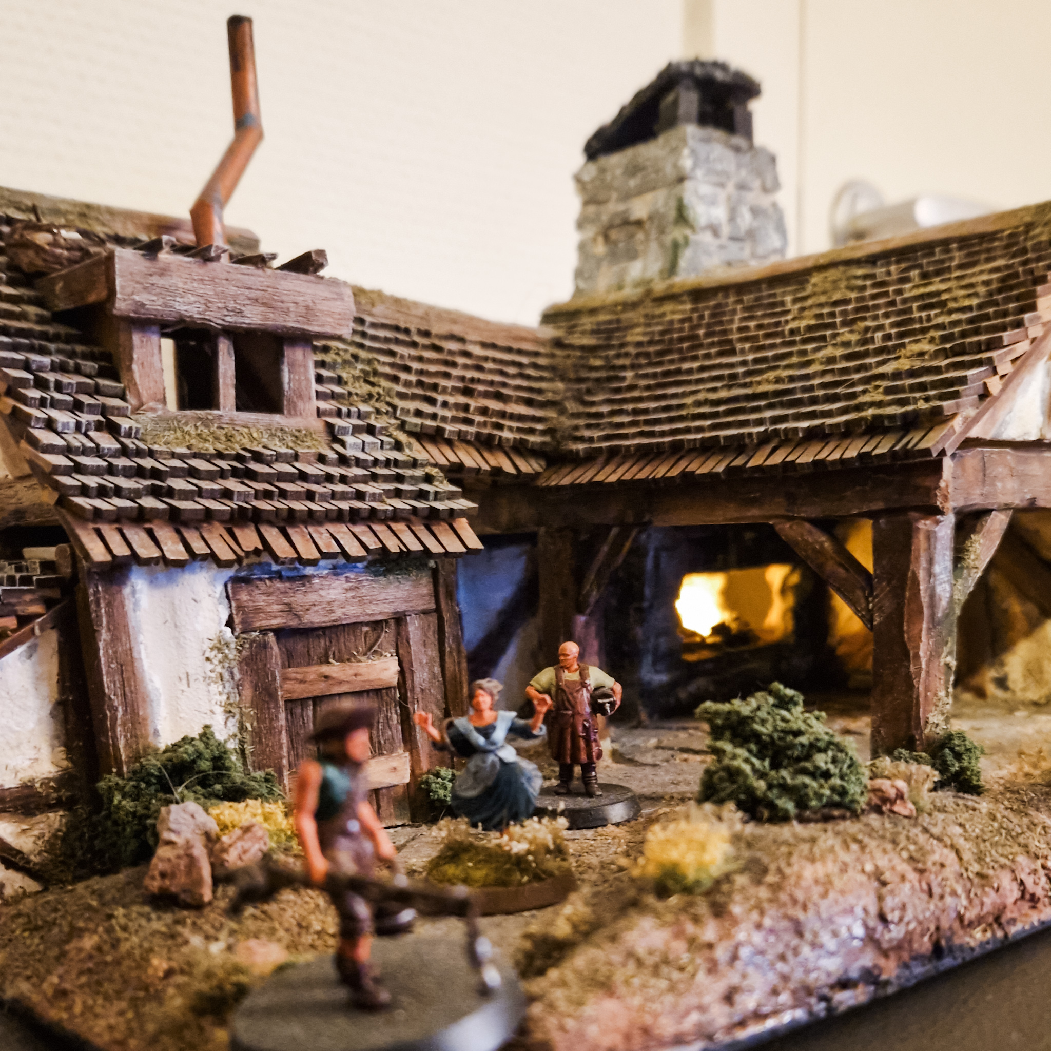 Close-up of miniature house with three miniature humans